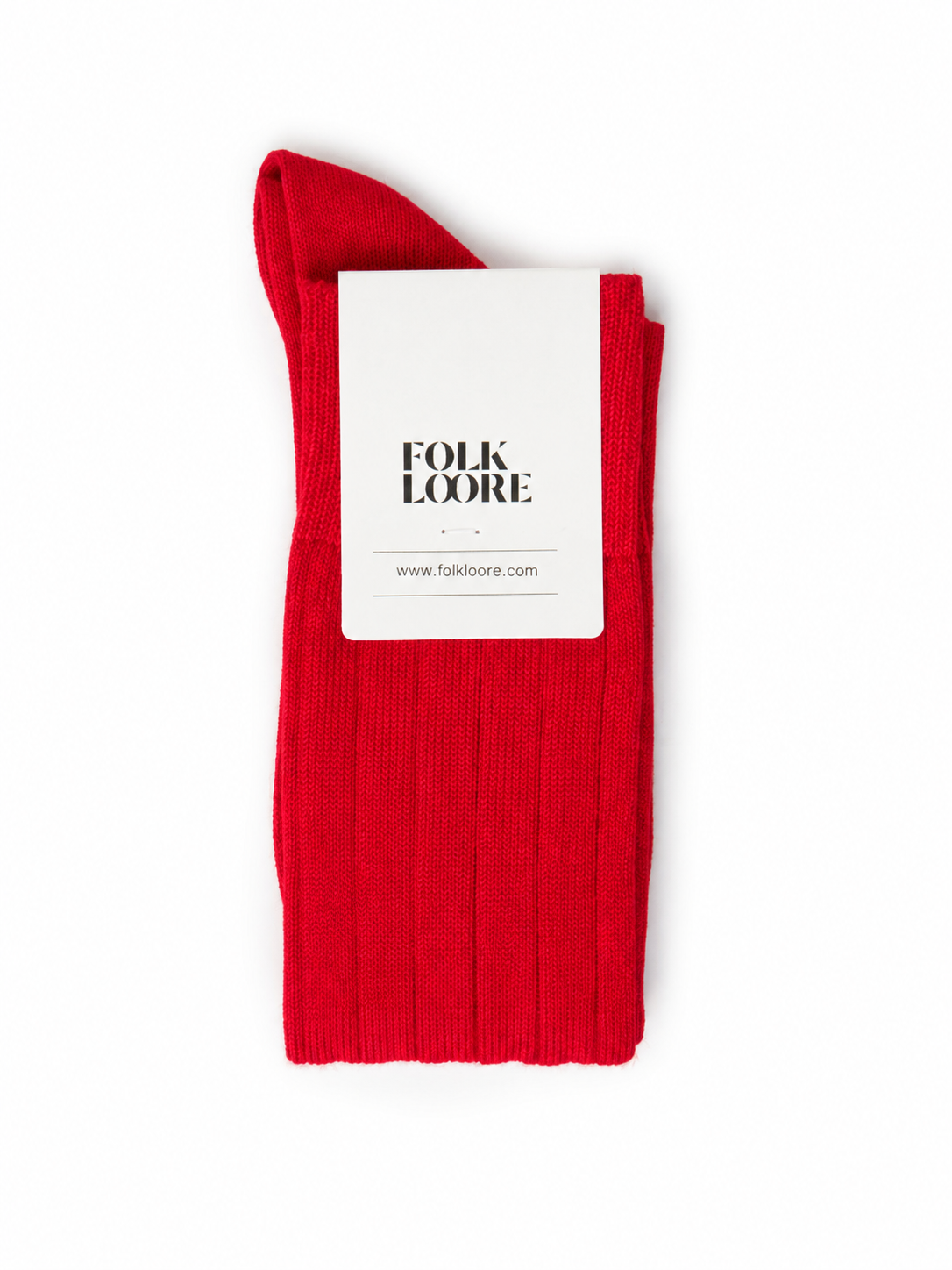 A single folded red ribbed knit sock with a white paper brand tag reading 'FOLK LOORE' on a plain white background. socks, cotton socks, high-knee socks, made in italy, handmade, artigianally made, fatto a mano, calzettoni invernali, winter cotton, calze di cotone, calze di cachemire, cachemire socks, cashmire socks