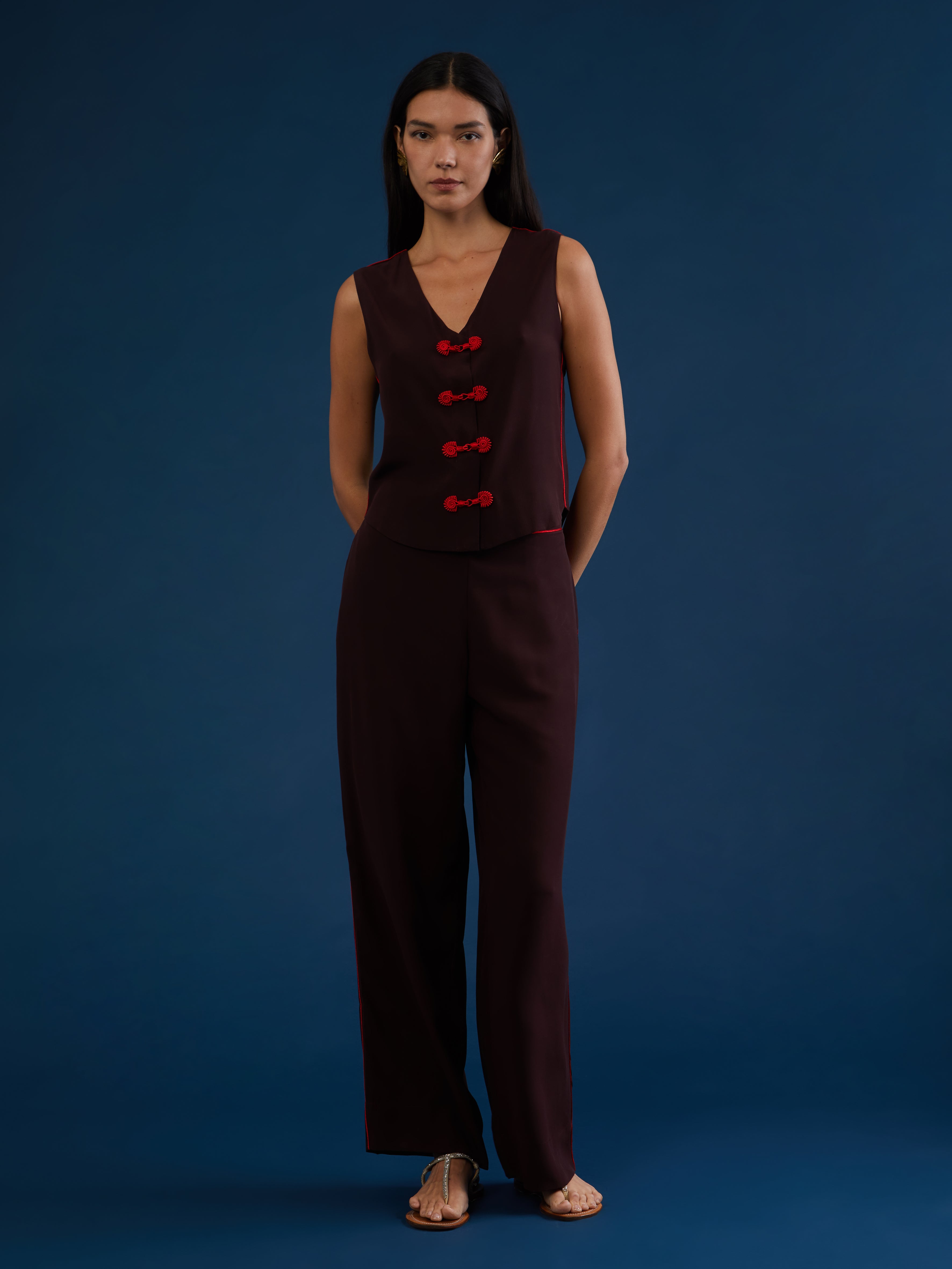 The pants are part of a chic and lightweight silk set crafted in Morocco featuring exquisite Italian silk fabrics. Designed for ultimate comfort and style, this set exudes effortless elegance with its relaxed fit. Each piece is meticulously detailed with Moroccan embroidery, adding a touch of artisanal craftsmanship to the ensemble. The wide-legs offer style and comfort, and its elasticated waist ensures an adjustable fit. DETAILS AND CARE Red with purple details 100% silk Elasticated waist Dry clean only M