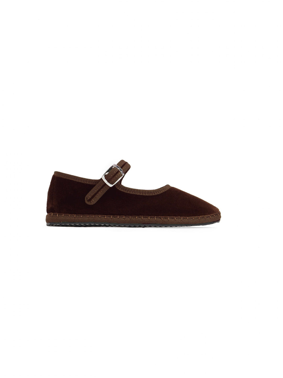 A single dark brown suede Mary Jane flat shoe with a matching brown strap and silver buckle, shown in profile against a solid white background. ETHICAL FASHION, CRAFTSMANSHIP, SUSTAINABLE FASHION, TRADITIONAL FASHION, TRADITIONAL ACCESSORIES, HANDMADE SHOES, HANDMADE ACCESSORIES, scarpe di velluto, velluto, fatto a mano in italia, MODA ETICA,  MODA SOSTENIBILE, MODA TRADIZIONALE, accessori tradizionali, scarpe fatto a mano, accessori fatti a mano, scarpe tradizionali, strap shoes, mary jane, strap friulane,