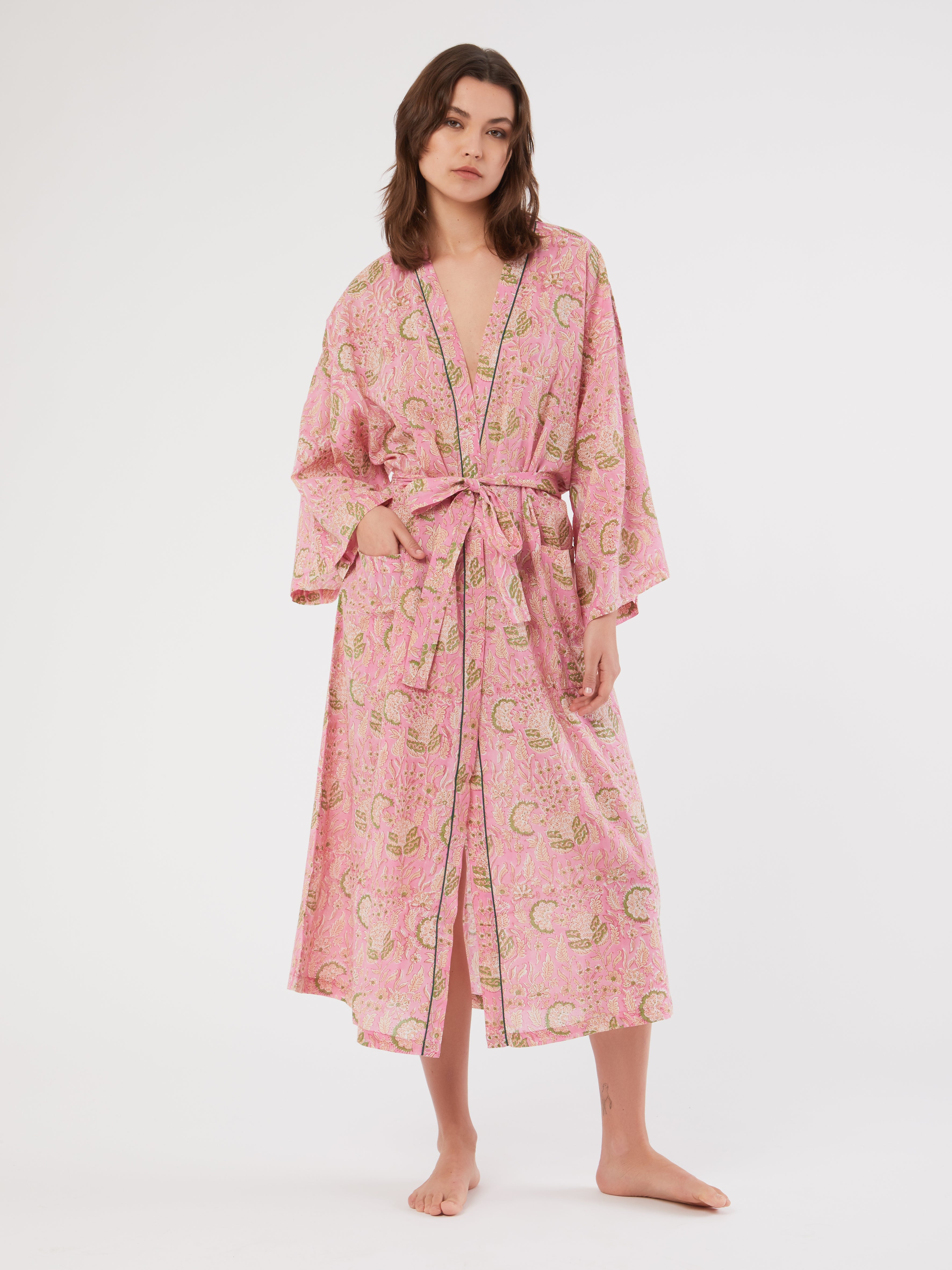 Unique cotton block-printed dressing gown, handmade in India by the local artisans. Refined with a belt and pockets, pack your nightgown for an exotic trip or wear it in the comfort of your own city home at winter time! DETAILS AND CARE Pink and green pattern with green piping 100% cotton Hand wash with cold water and mild detergent Do not soak Dry in the shade, direct sunlight can fade color As all handmade prints, there may be a small amount of residual color in the fabric ONE SIZE